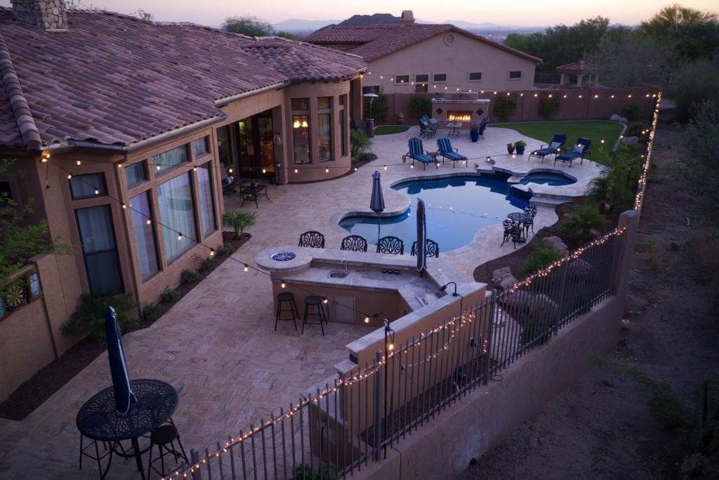 A stunning, aerial view of a backyard example of a well-thought-out outdoor kitchen cost plan and the results that you can achieve.